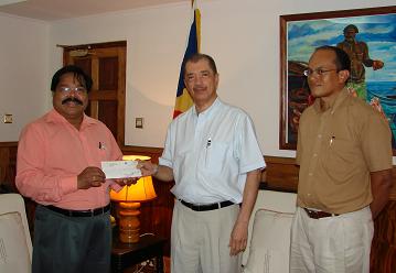 Dr. Ramadoss presenting his personal check to President Michel.