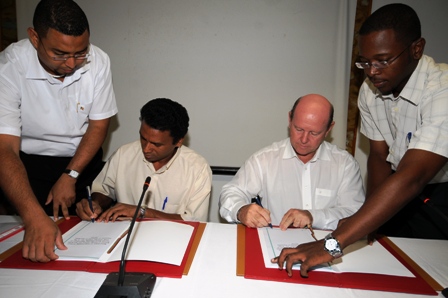 Mr Faure (left) and Mr St Ange signing the memorandum of understanding