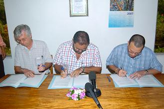 Skerrett, Savy and Jumeau signing the agreement  for ICS to implement conservation programmes on outer islands.