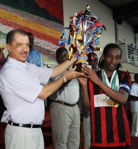 President Michel hands over the cup to St Michel’s captain Freminot