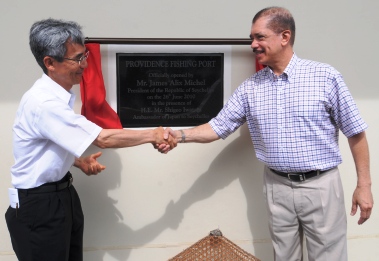 President Michel and Ambassador Iwatani shake hands after unveiling the plaque to officially open the fishing port