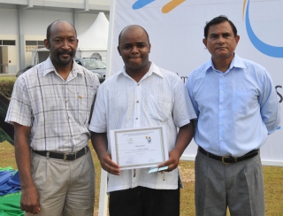 Winner Mr Adeline (centre) with Minister Meriton (left) and Mr Gopal