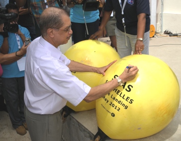 Description: President Michel signing the two buoys previously attached to the fore end of the cable