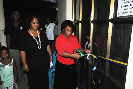 Description: Joenise’s mother cutting the ribbon to officially launch the exhibition