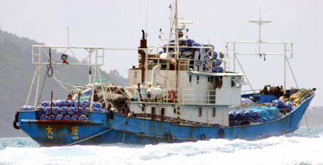 The Chinese fishing boat loaded with blue plastic barrels which could be used to ship sea cucumbers.