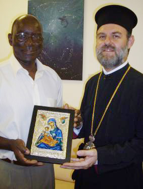 The Archbishop presents Vice-President Belmont with the icon of the Holy Mother of God of Corfu