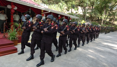 Members of the new unit march past as they are introduced to President Michel and other dignitaries and guests