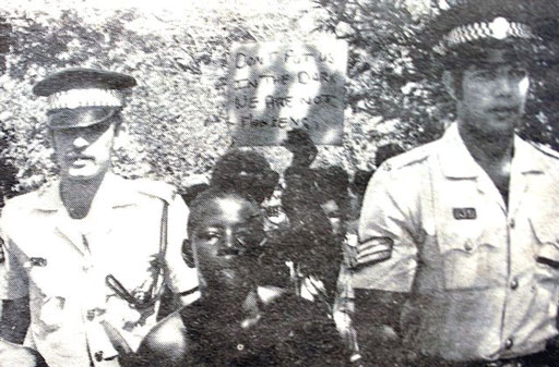 Police officers arresting students.