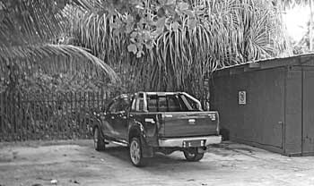 Trucks belonging to some rich arabs is parked next to container outside the Plantation Club resort.