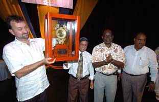 Captain Savy lifts up trophy given by Lion's Club.