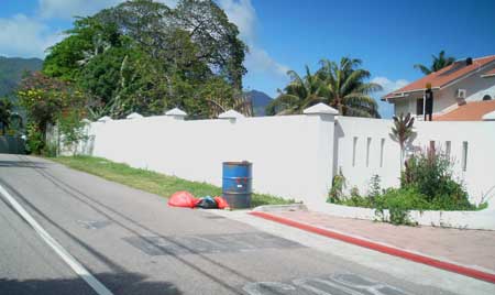 An illegal public bin next to posh apartments. The dogs have already rummaged through its contents.  